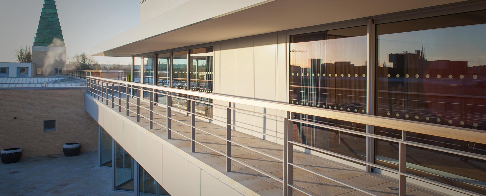 Wide span of aluminium sliding doors that lead onto a balcony