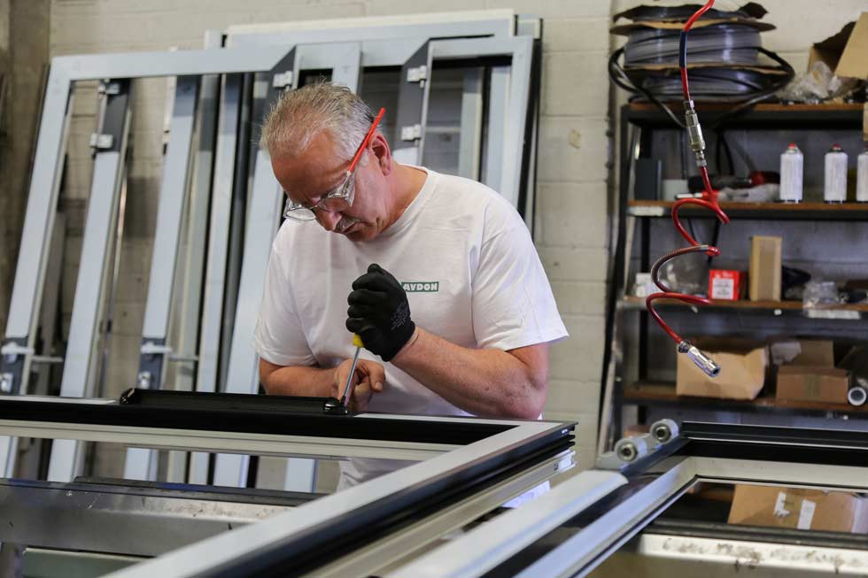 One of our engineers with safety glasses on whilst working on one of our window systems
